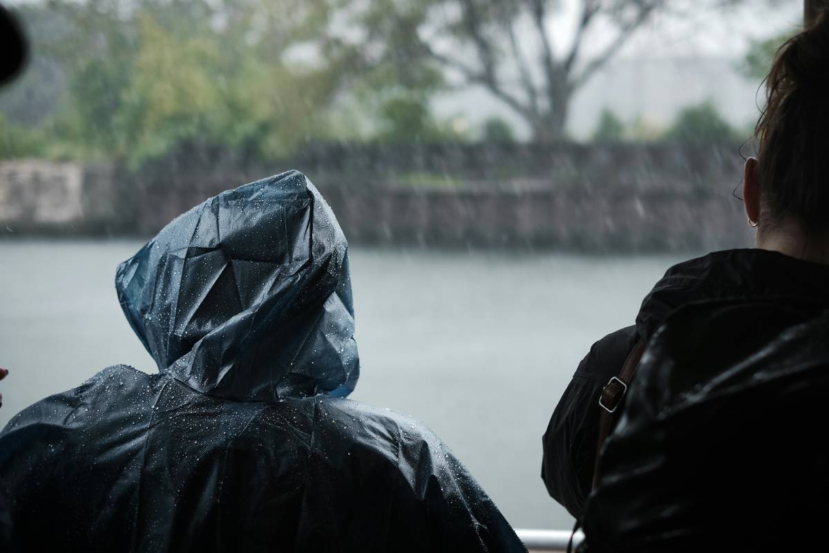 Hiker wearing lightweight poncho for Instant Rain Coverage during mountain downpour